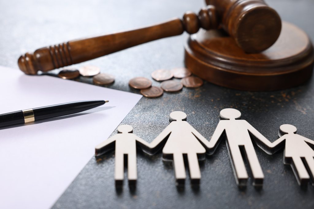 coins on a table with a gavel and a document